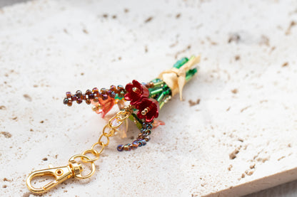 Colorful beaded keychain with flowers on a textured surface