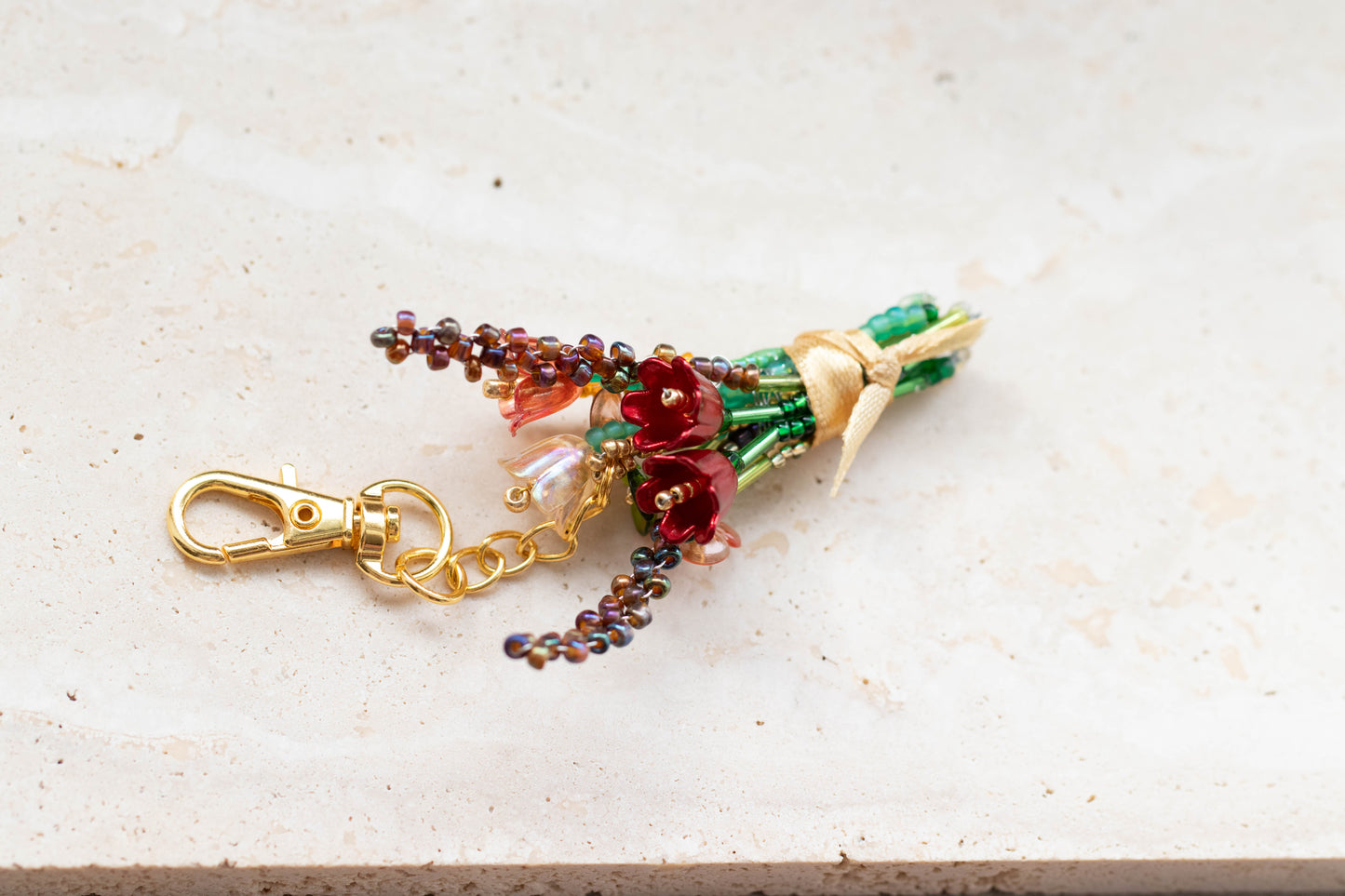 Decorative keychain with floral design on a light surface