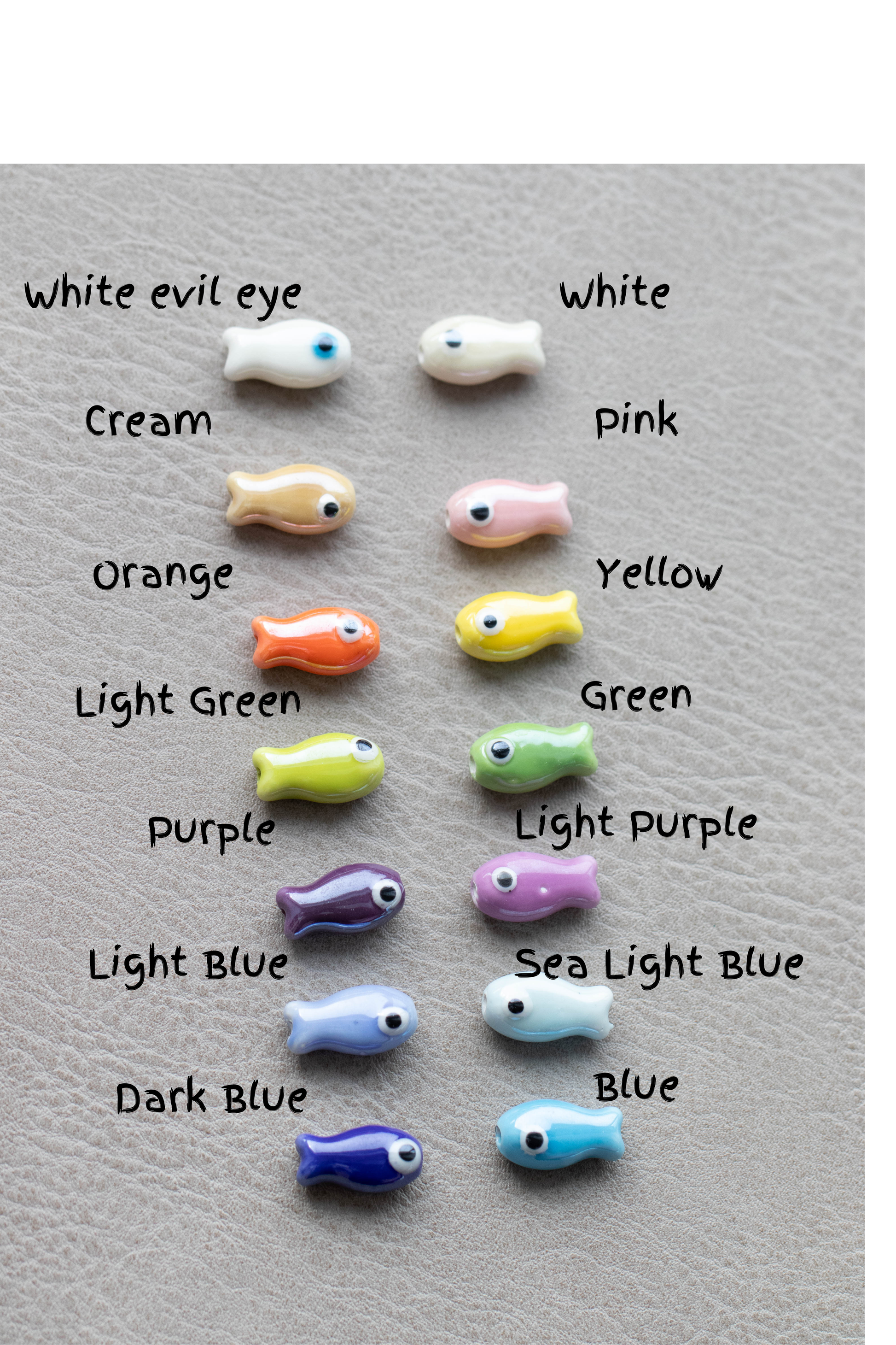 Assorted colored evil eye charms on a gray background with labels.